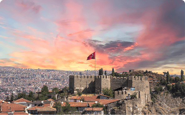 Historic fort overlooking cityscape at dusk