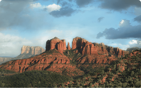 Red rock formations under cloudy sky