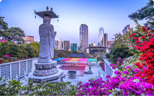 Buddha statue overlooking city skyline