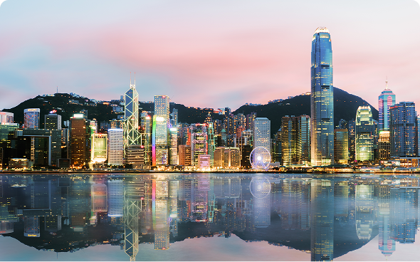 Illuminated skyscrapers reflecting in water