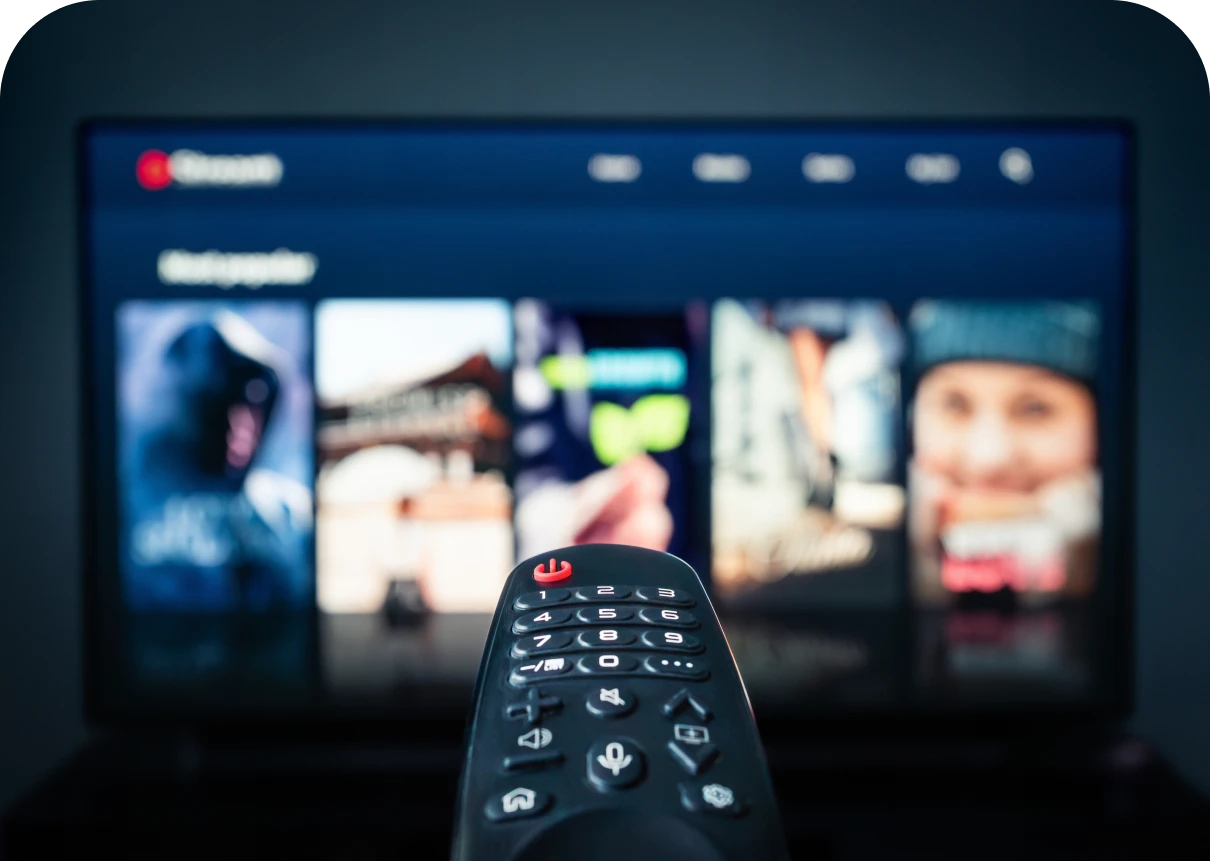TV remote pointing at streaming service screen