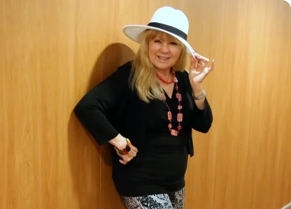 Woman posing in hat and necklace