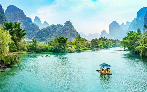 Bamboo raft on river with karst mountains